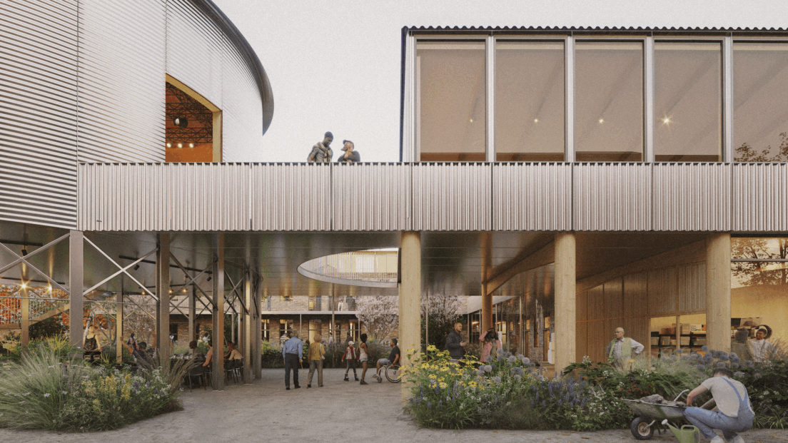 the image shows a community space - there is a bridge/walkway with two people standing on it and below there is a open air walkway path with lots of green plants and people walking unedrneath
