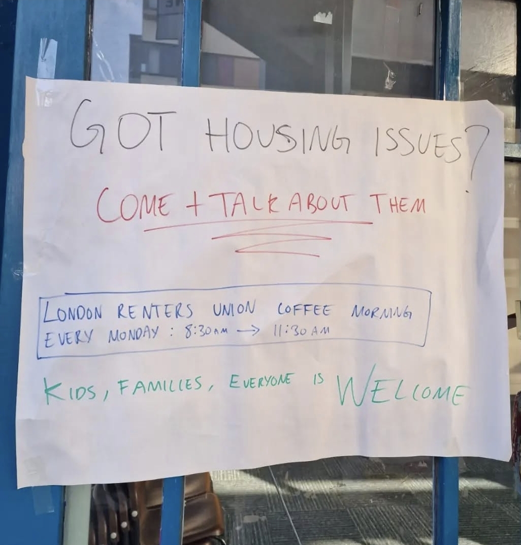 The image shows a white paper sign, with the words, Got Housing Issues written at the top in black.