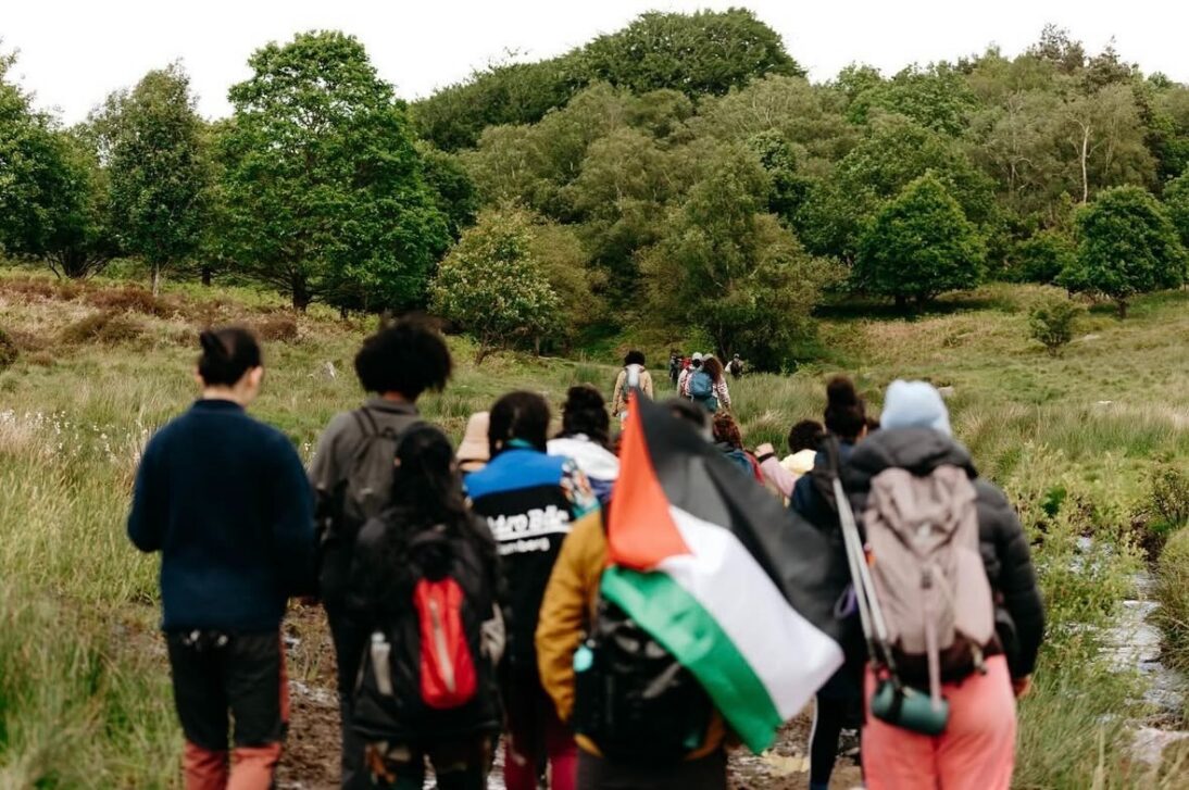 The image shows a group of walkers going on a hike through the countryside