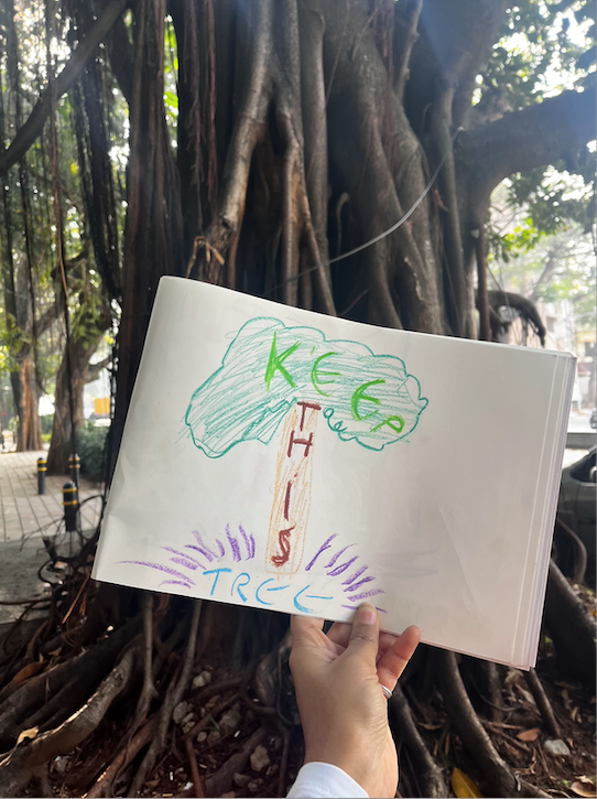The image shows a children's drawing of a tree with the words "keep this" on it.