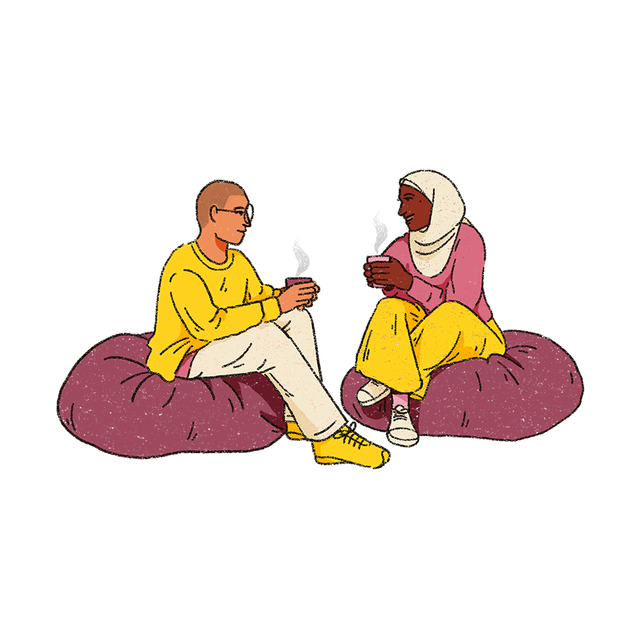 two people are sat on beanbags in conversation together with a warm drink