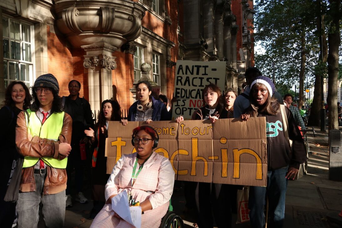 the image shows a group of people attending an anti racism protest